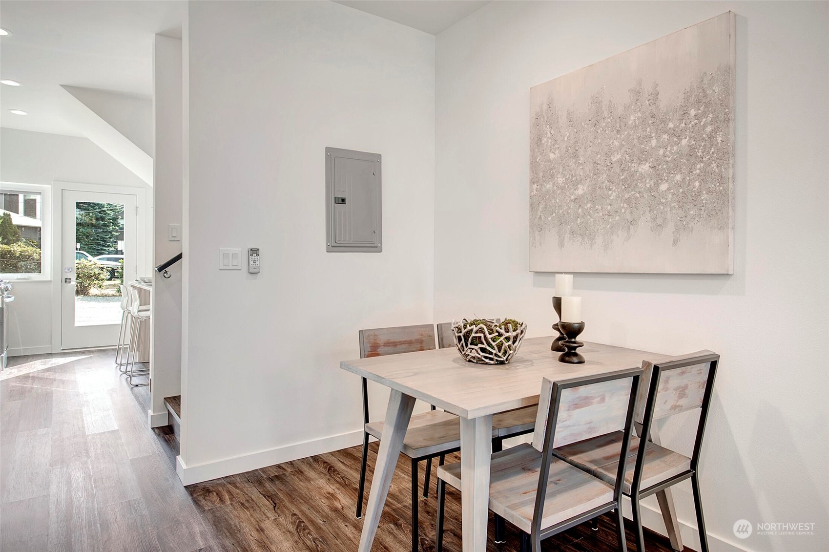 10170 Holman Road Northwest, Unit G Seattle, WA 98133 - Photo 6 of 23 a view of a dining room with furniture and wooden floor