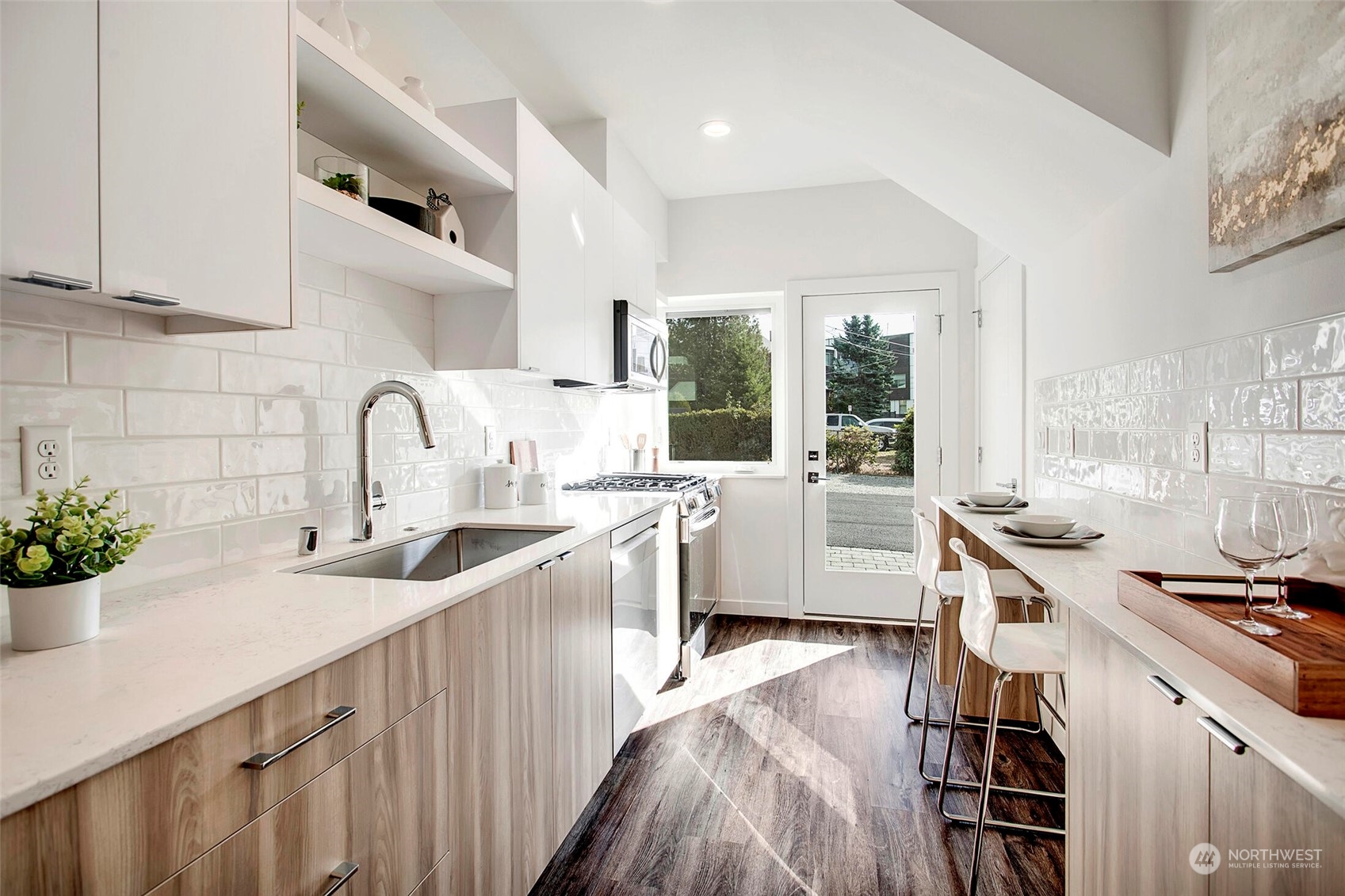 10170 Holman Road Northwest, Unit G Seattle, WA 98133 - Photo 7 of 23 a kitchen with sink a stove and cabinets