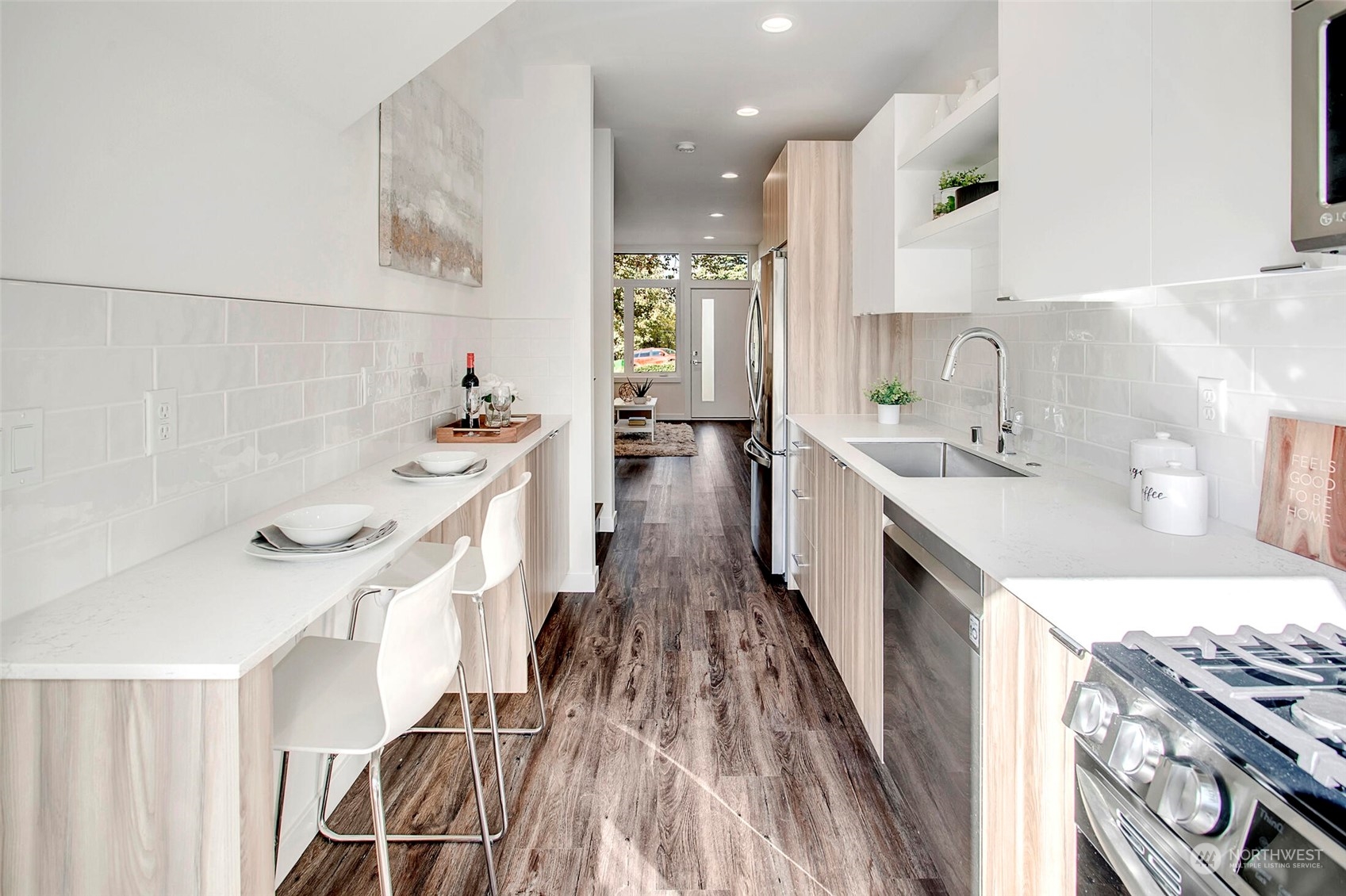10170 Holman Road Northwest, Unit G Seattle, WA 98133 - Photo 9 of 23 a large white kitchen with a large window
