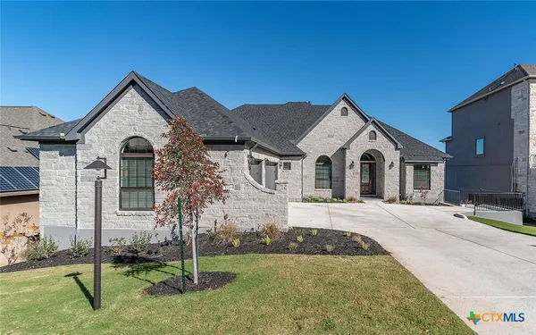 a front view of a house with a yard and garage