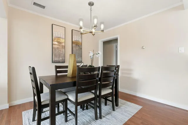 a view of a dining room with furniture and a chandelier
