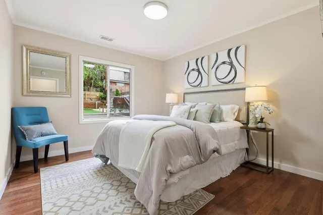 a bedroom with a bed and a chair