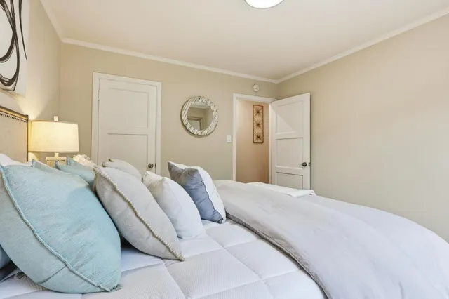 a bedroom with a bed and a lamp