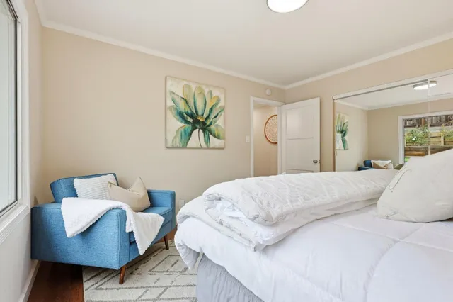 a bedroom with a bed and a couch