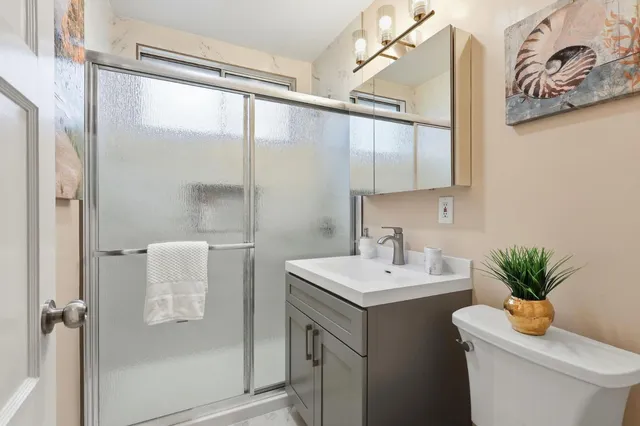 a bathroom with a sink toilet and shower