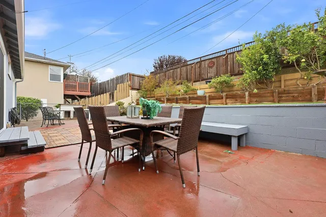 a view of a patio with table and chairs and potted plants