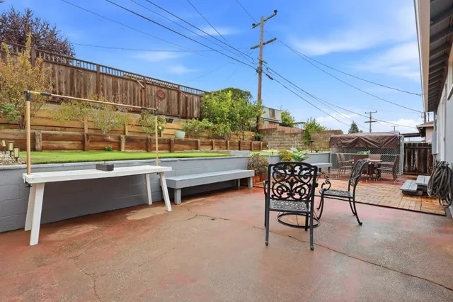 a roof deck with table and chairs