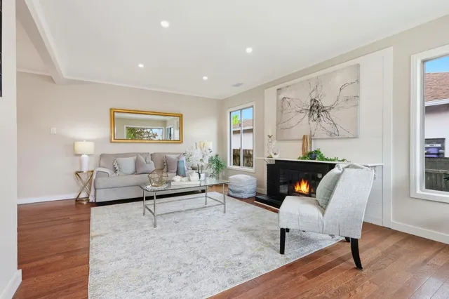 a living room with furniture and a painting on the wall