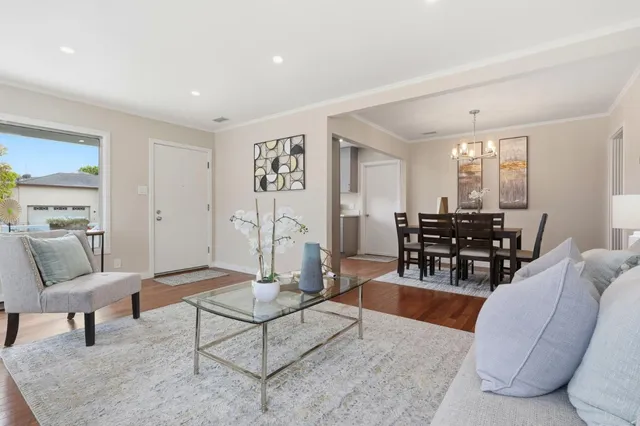 a living room with furniture and wooden floor