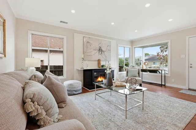 a living room with furniture and a fireplace