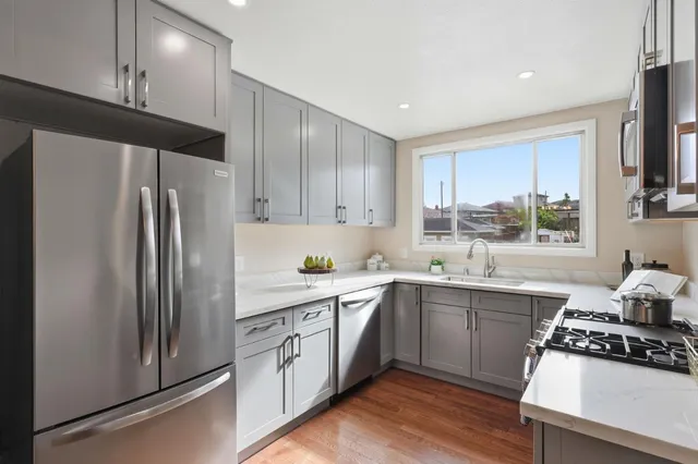 a kitchen with a sink stove and refrigerator