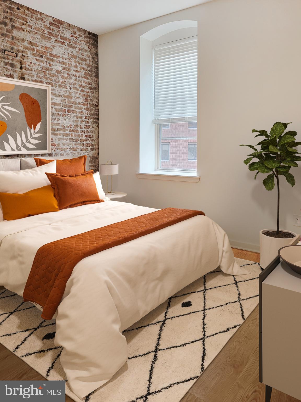 261-269 South 9th Street, Unit 504 Philadelphia, PA 19107 - Photo 11 of 27 a bedroom with a bed and a potted plant