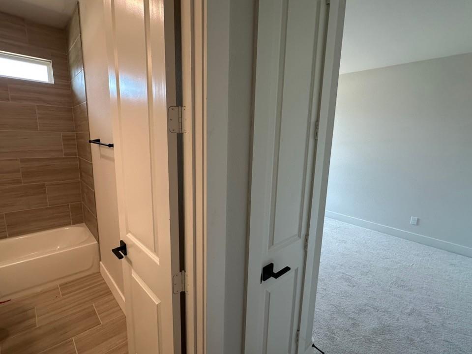 605 Brown Road Leonard, TX 75452 - Photo 18 of 25 Bathroom featuring a white tub, tiled walls, and a rectangular window