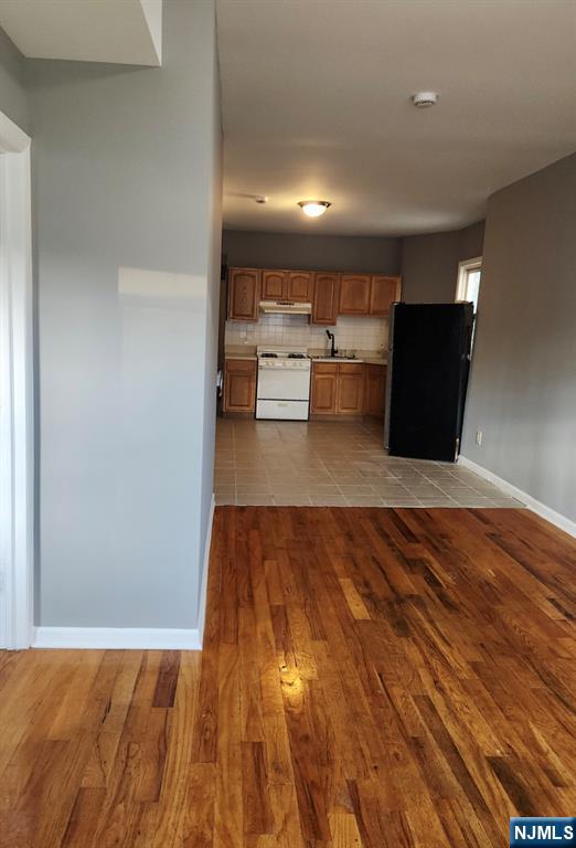 93 Astor Street, Unit 2 Newark, NJ 07114 - Photo 3 of 5 a view of a kitchen with a sink and a refrigerator