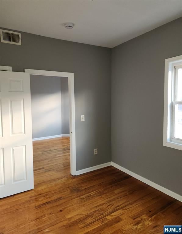 93 Astor Street, Unit 2 Newark, NJ 07114 - Photo 5 of 5 a view of empty room with wooden floor and fan