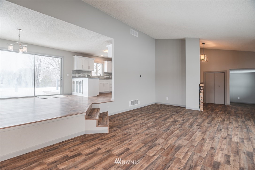 8037 Valley Road Northeast Moses Lake, WA 98837 - Photo 19 of 39 a view of empty room with wooden floor and a window