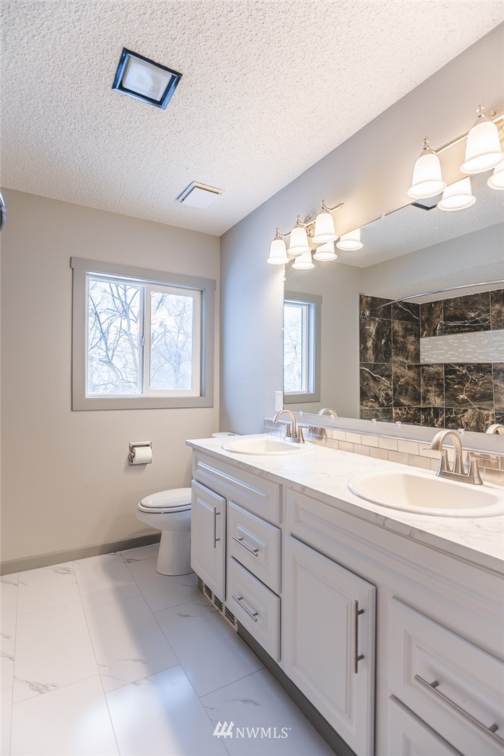 8037 Valley Road Northeast Moses Lake, WA 98837 - Photo 32 of 39 a spacious bathroom with a double vanity sink mirror and toilet