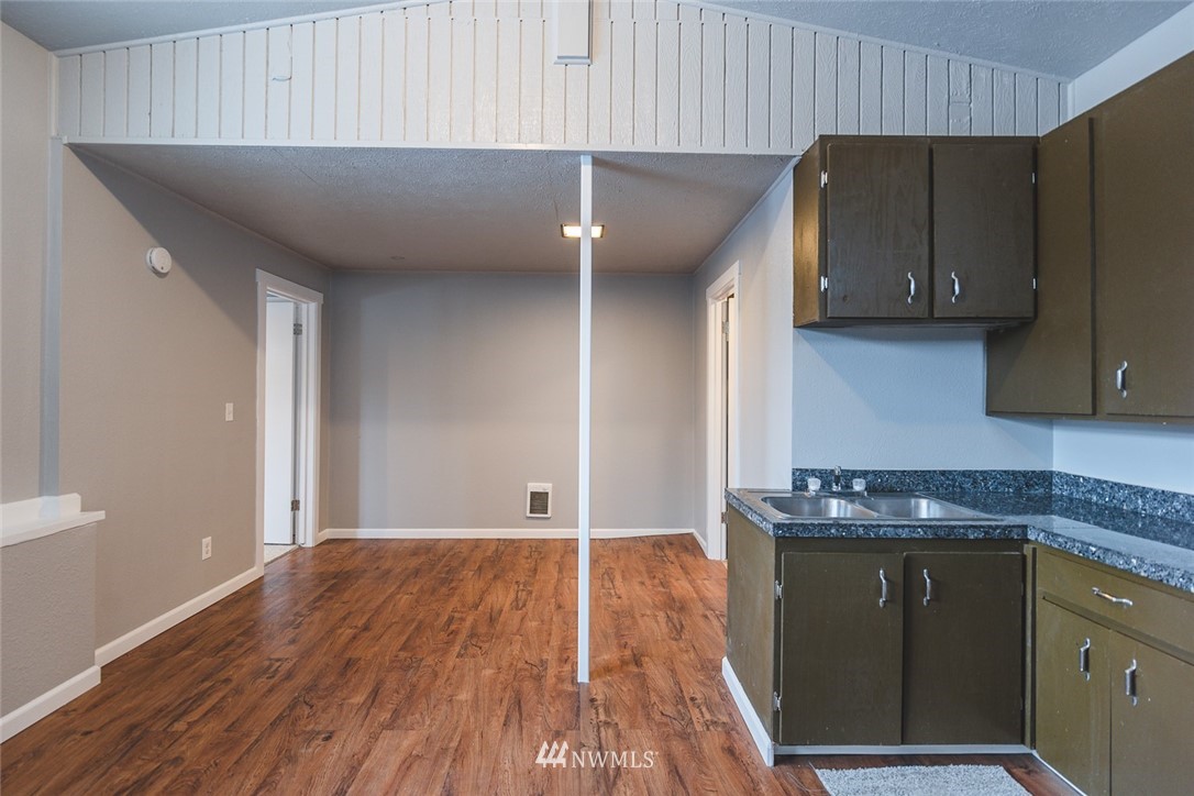 8037 Valley Road Northeast Moses Lake, WA 98837 - Photo 37 of 39 a kitchen with wooden cabinets and a sink