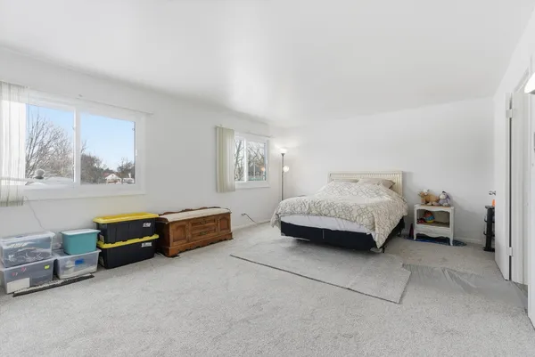 a spacious bedroom with a bed and a couch