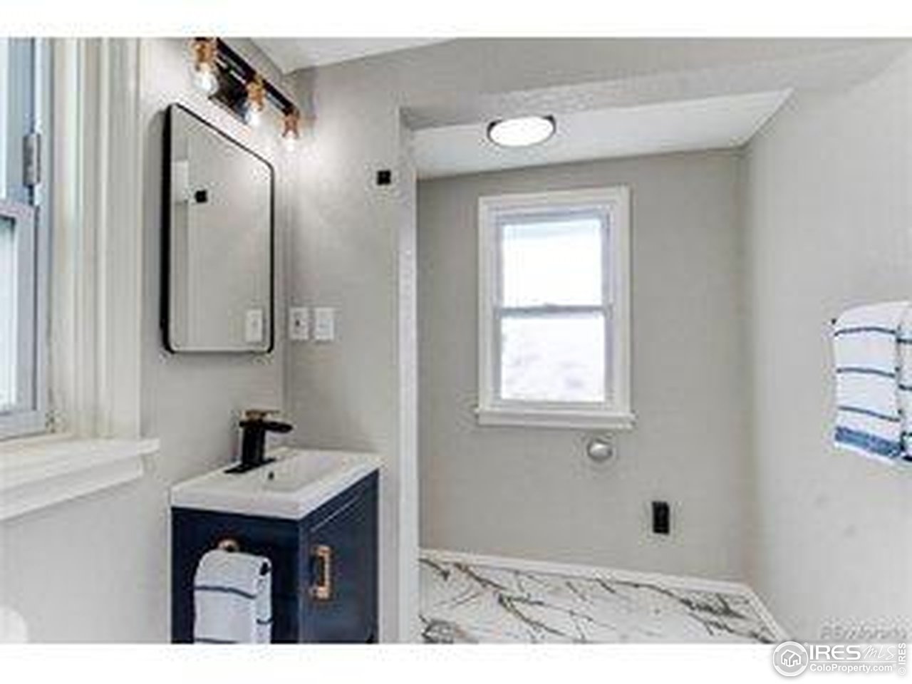 784 South 3rd Avenue Brighton, CO 80601 - Photo 15 of 17 a bathroom with a sink and a mirror
