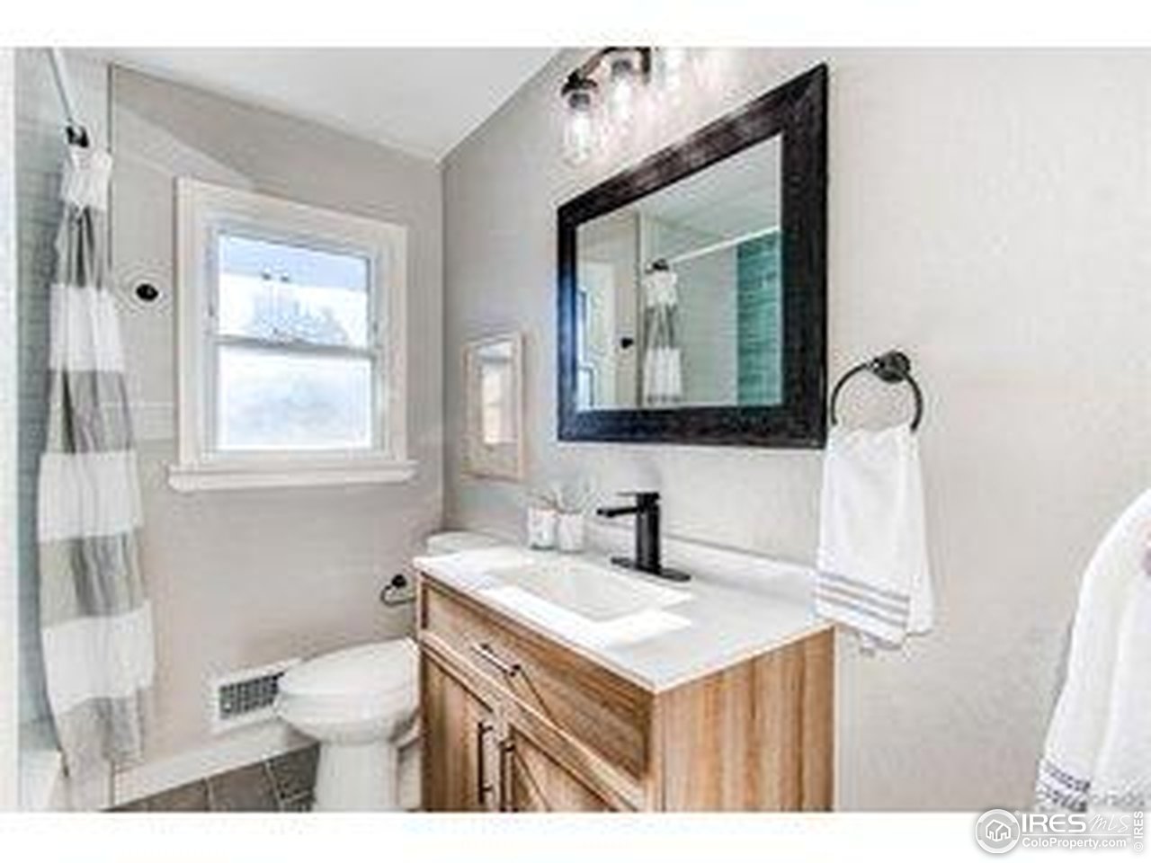 784 South 3rd Avenue Brighton, CO 80601 - Photo 17 of 17 a bathroom with a toilet sink and mirror