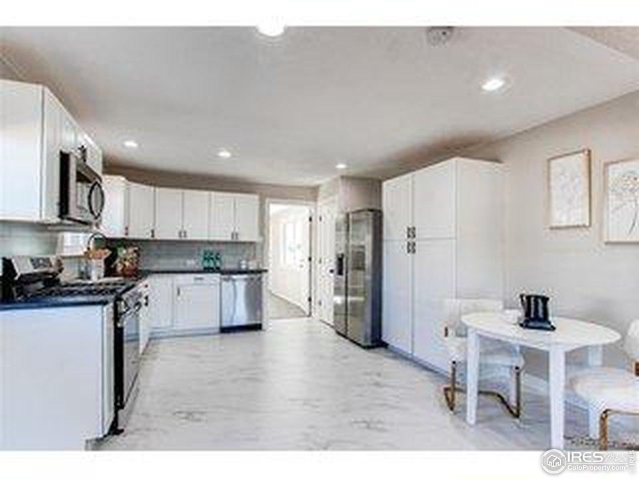 784 South 3rd Avenue Brighton, CO 80601 - Photo 2 of 17 a kitchen with stainless steel appliances kitchen island granite countertop a refrigerator and a stove top oven