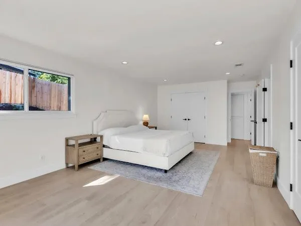 a bedroom with a bed and window