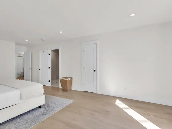 a large bedroom with a bed and a couch