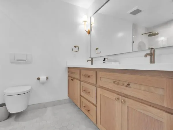 a bathroom with a double vanity sink and a toilet