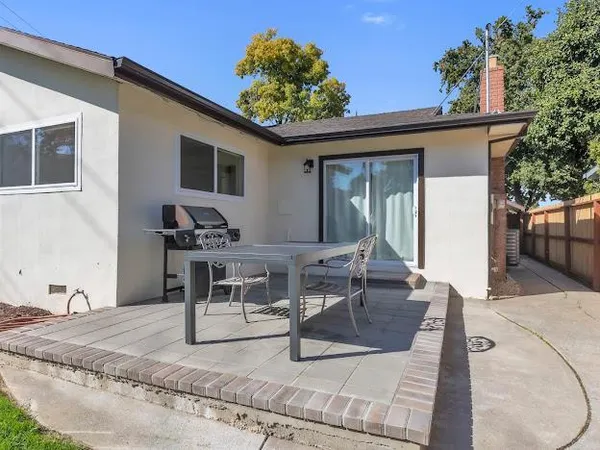 a view of a backyard with sitting area