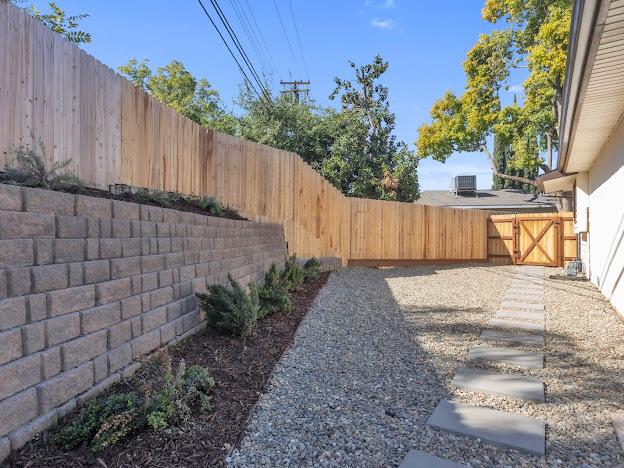 5841 Sharps Circle Carmichael, CA 95608 - Photo 27 of 38 a view of a backyard with potted plants and wooden fence