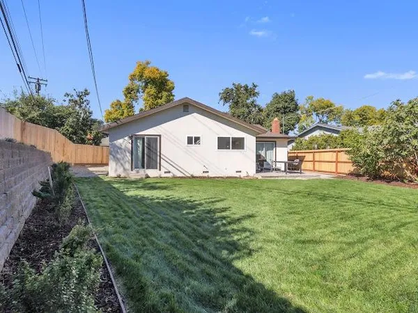 an aerial view of a house with a yard