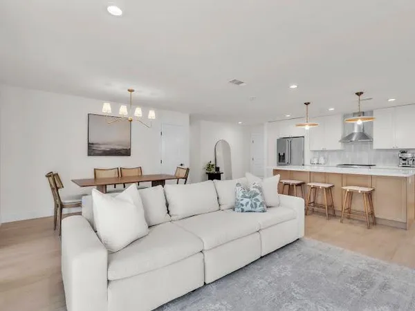 a living room with furniture and kitchen view
