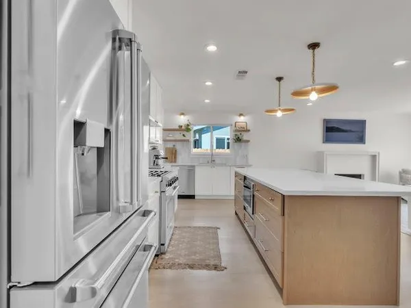 a kitchen with stainless steel appliances a refrigerator and a sink