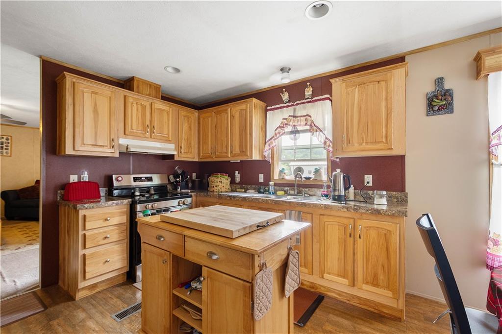 534 Finks Run Road McDonald, PA 15057 - Photo 28 of 35 a kitchen with a stove a sink a refrigerator a window and cabinets
