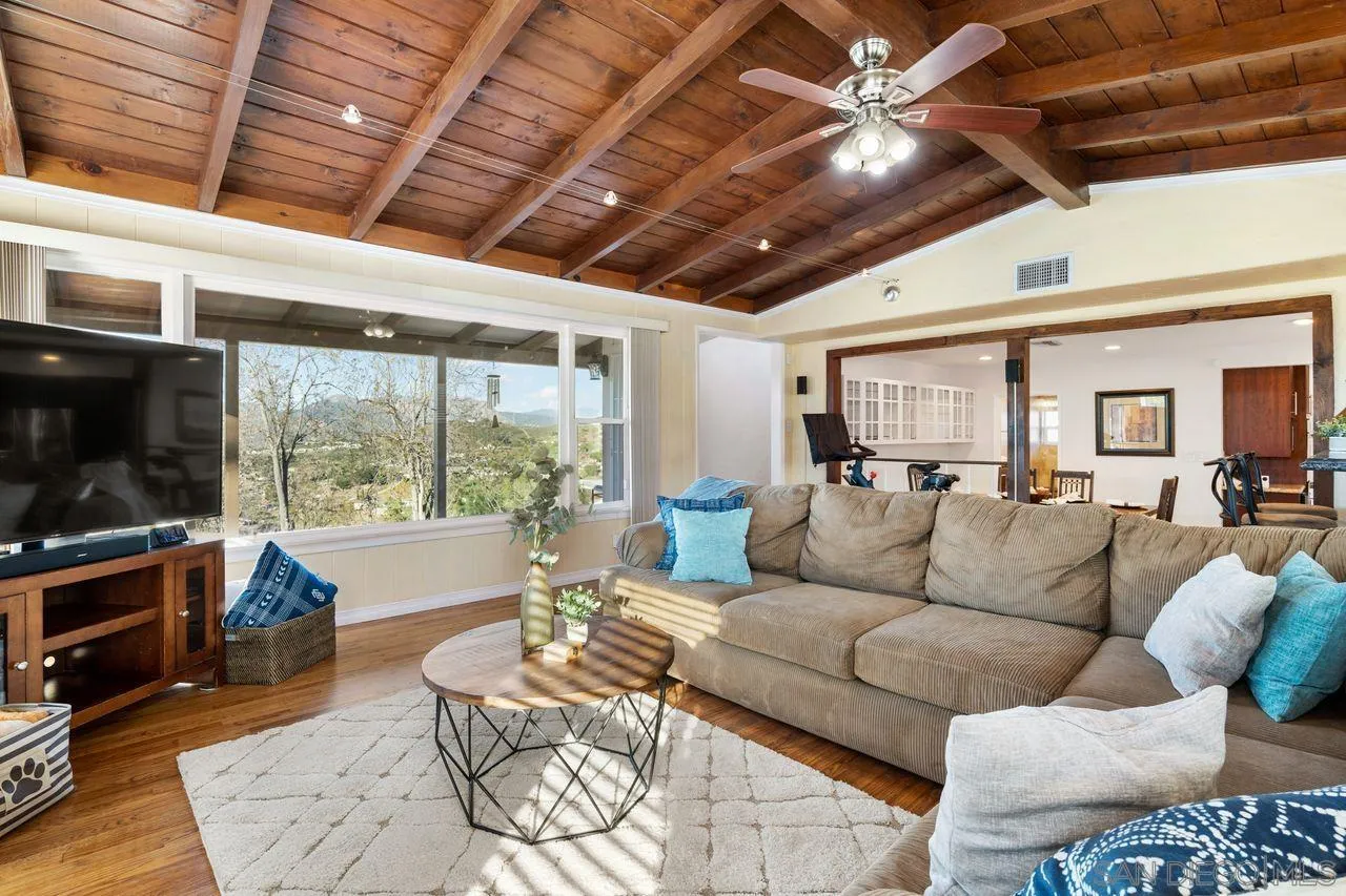 8601 Gardena Road Lakeside, CA 92040 - Photo 3 of 25 a living room with furniture a flat screen tv and a large window