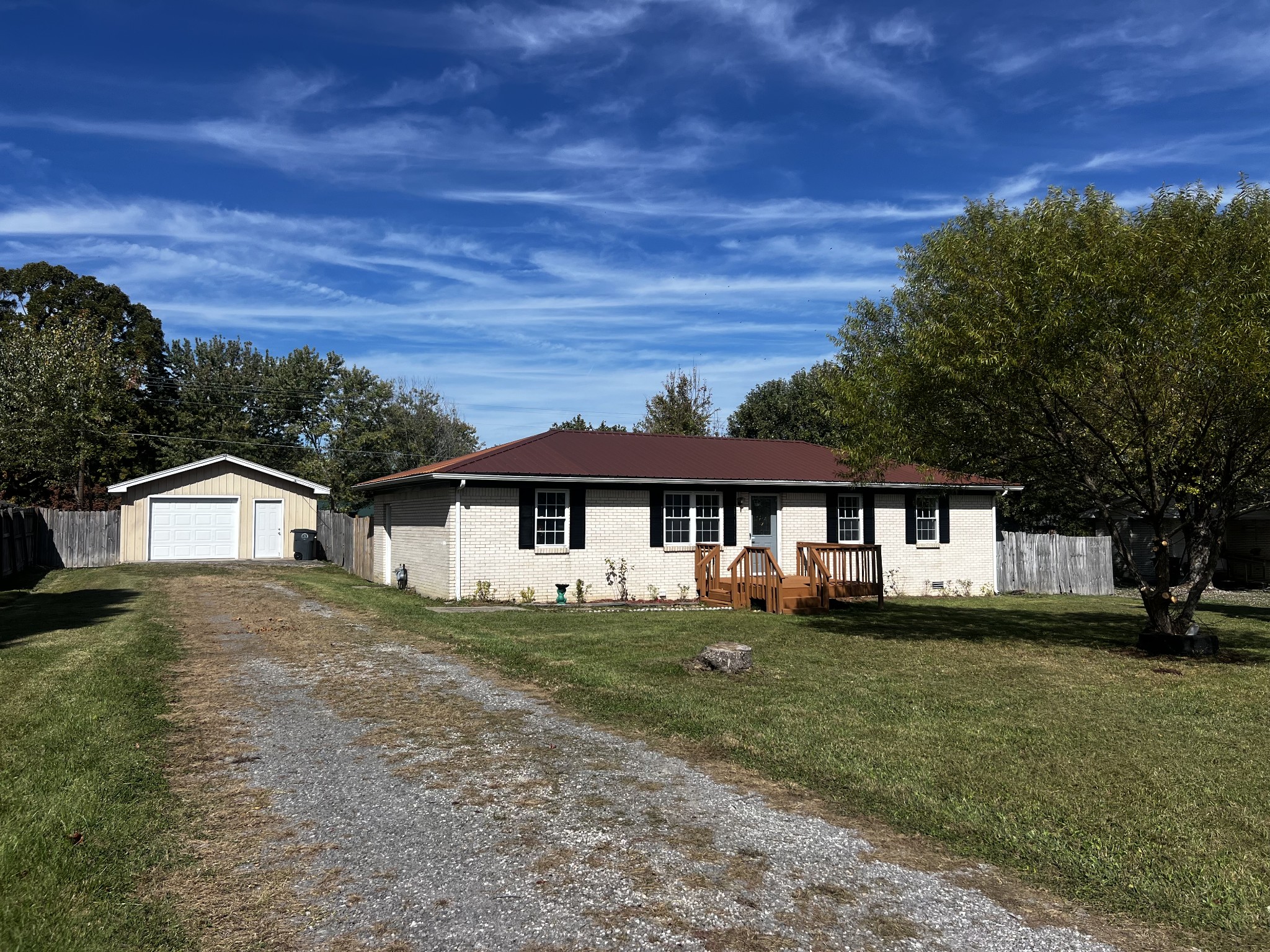 641 Coolidge Road Lafayette, TN 37083 - Photo 1 of 17 a front view of a house with a garden