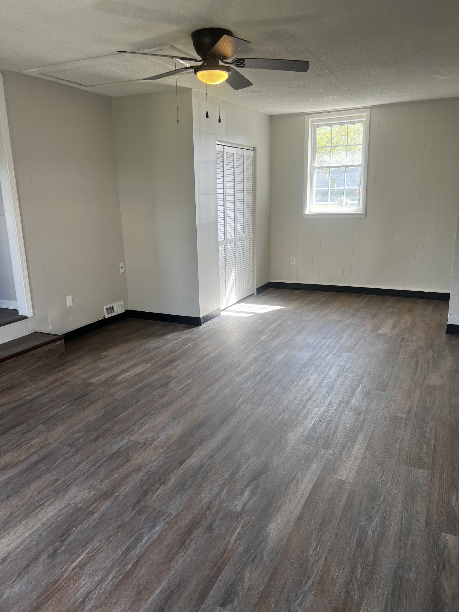 641 Coolidge Road Lafayette, TN 37083 - Photo 15 of 17 an empty room with wooden floor ceiling fan and windows