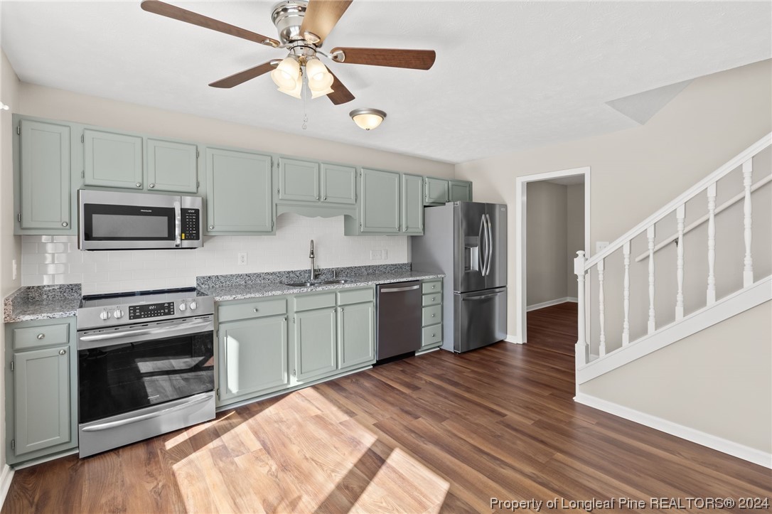 1030 Rim Road Fayetteville, NC 28314 - Photo 13 of 33 a kitchen with stove cabinets and stainless steel appliances
