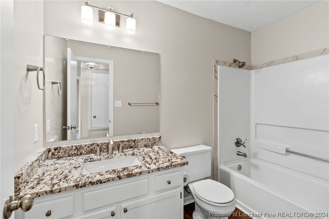 1030 Rim Road Fayetteville, NC 28314 - Photo 22 of 33 a bathroom with a granite countertop sink toilet and shower