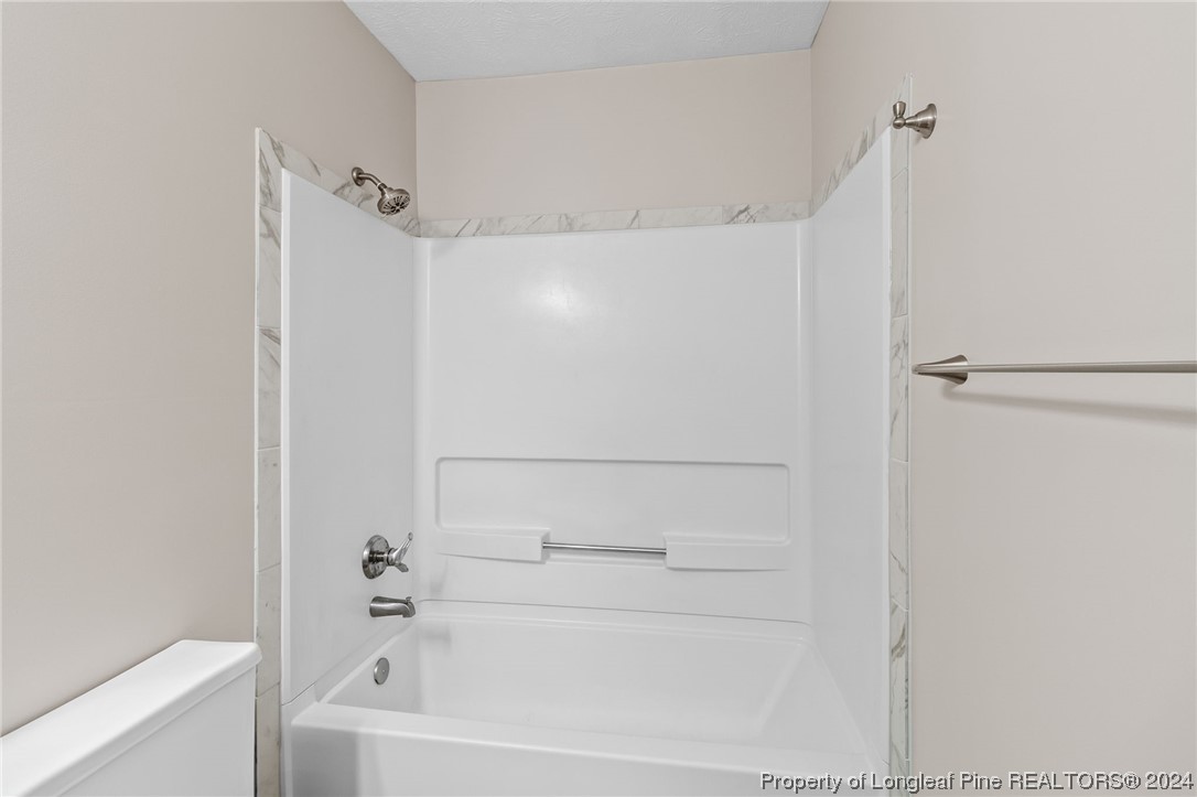 1030 Rim Road Fayetteville, NC 28314 - Photo 24 of 33 a bathroom with a bathtub and a shower