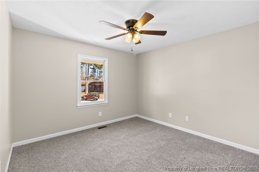 1030 Rim Road Fayetteville, NC 28314 - Photo 28 of 33 an empty room with a window and a fan