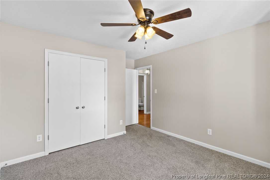 1030 Rim Road Fayetteville, NC 28314 - Photo 29 of 33 an empty room with a ceiling fan and a window