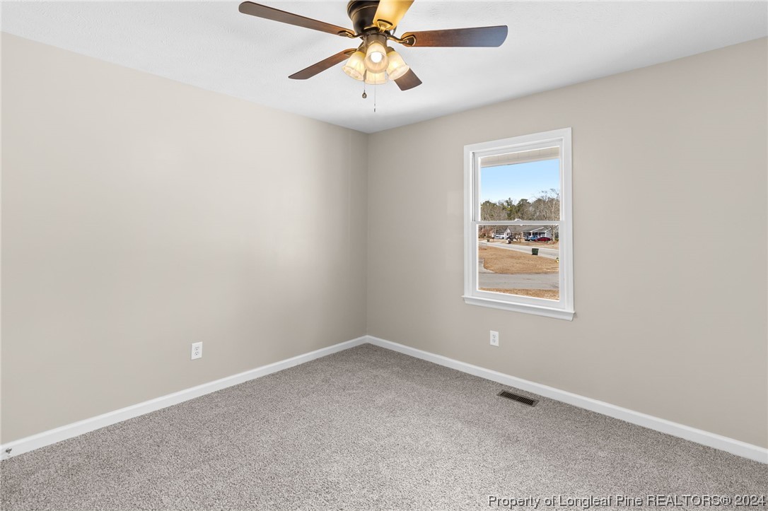 1030 Rim Road Fayetteville, NC 28314 - Photo 30 of 33 an empty room with chandelier fan