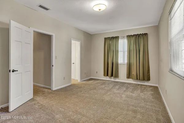a view of a house with a yard from a balcony