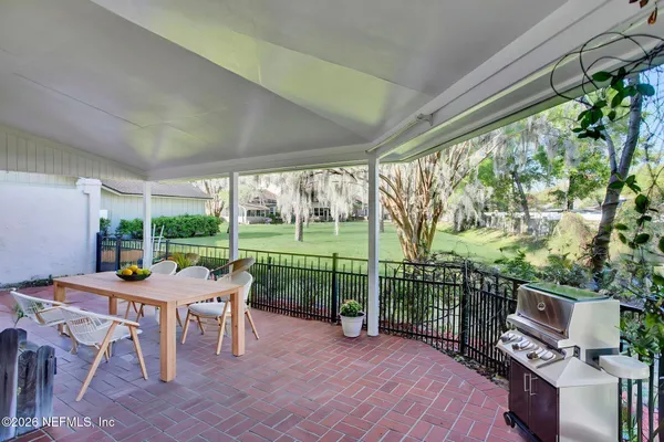 a view of a porch with wooden floor and fence