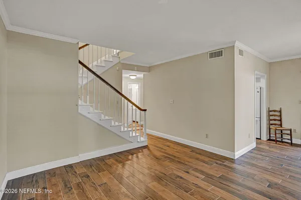 a bedroom with a bed and a chandelier fan
