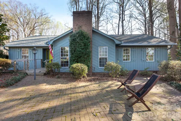 a view of backyard with outdoor seating and house in the background