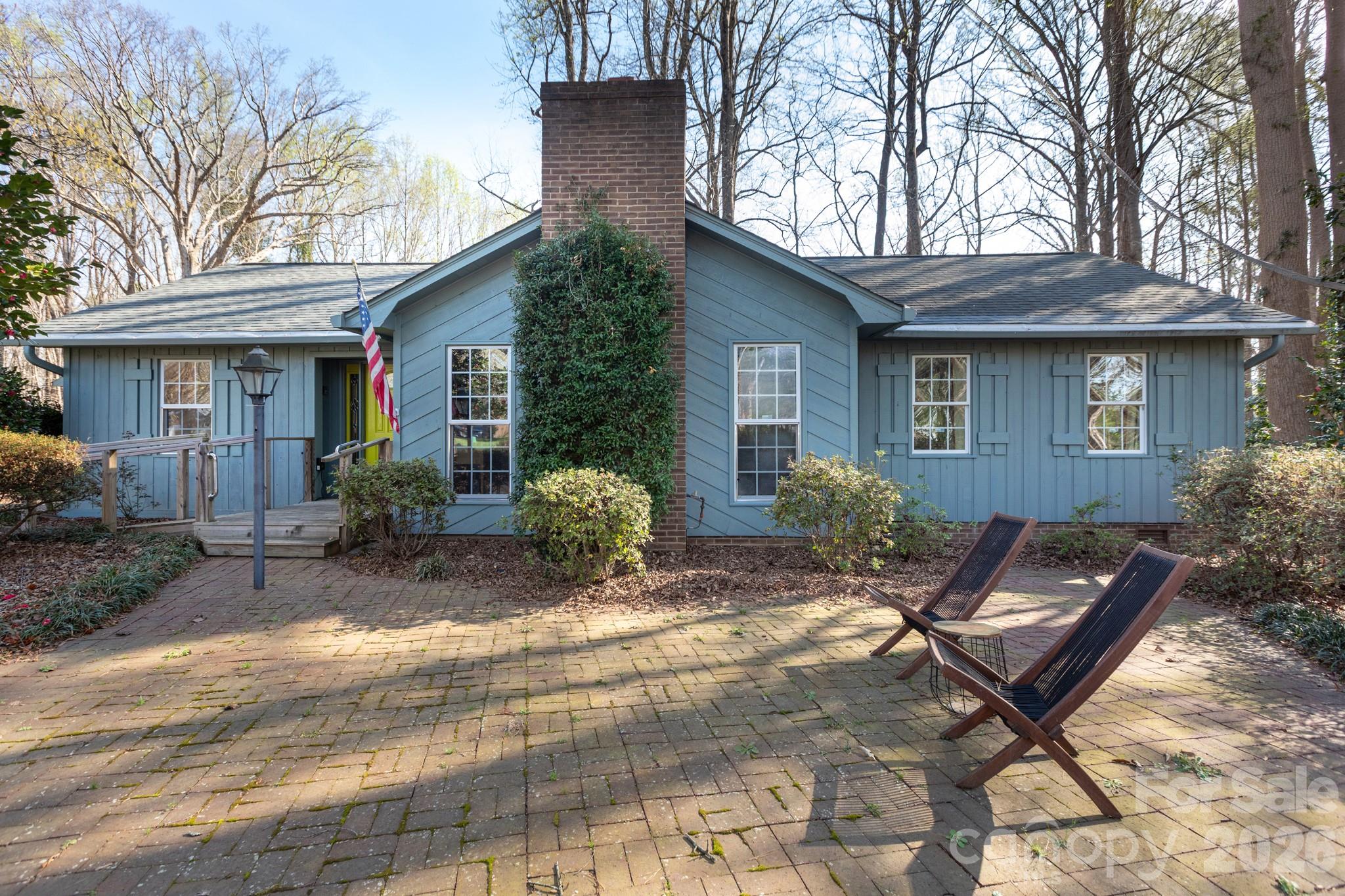 a view of backyard with outdoor seating and house in the background