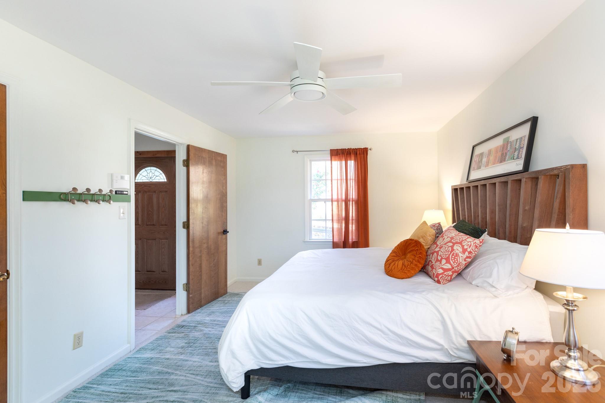 7423 Kuck Road Mint Hill, NC 28227 - Photo 15 of 31 a bedroom with a bed and dresser with wooden floor